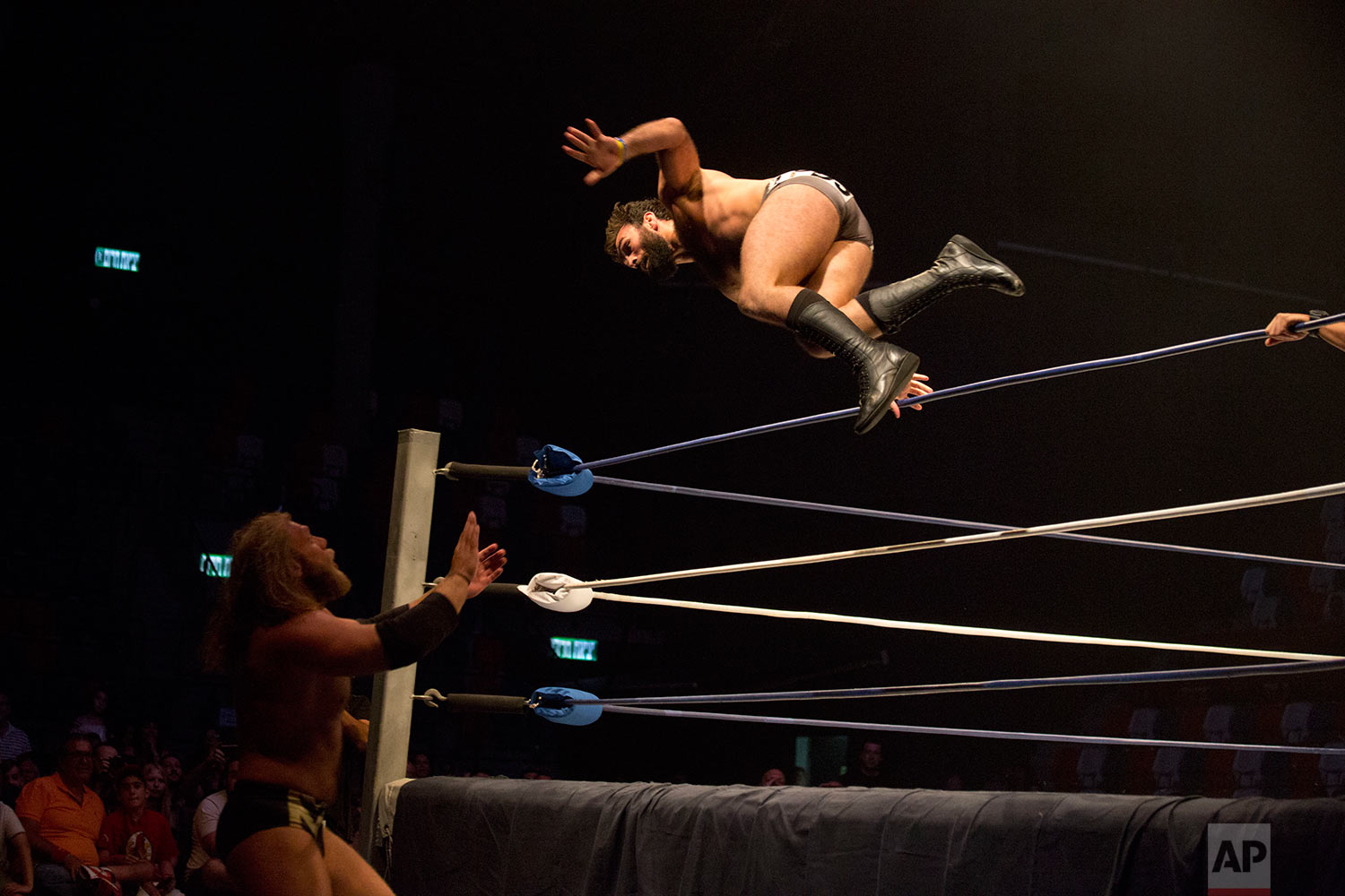 Wrestler David Starr jumps towards Juran Simmons during The Rage Wrestling Mega Show in Tel Aviv, Israel, Sunday, July 9, 2017.(AP Photo/Ariel Schalit)
