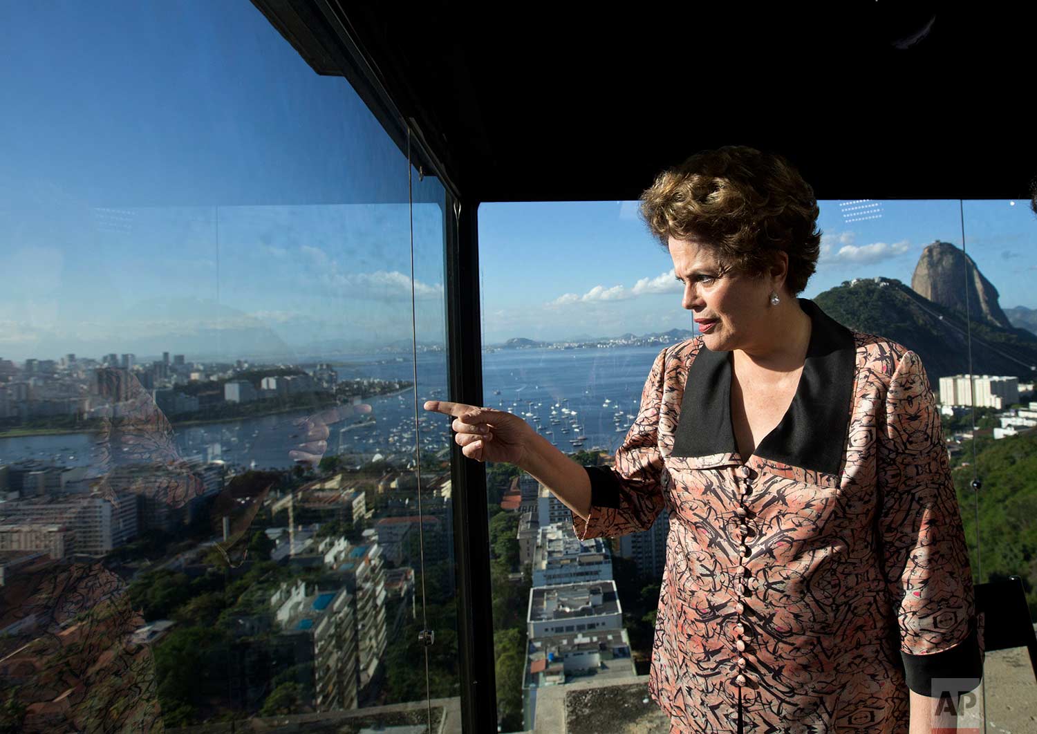 Brazil's former President Dilma Rousseff looks out over Guanabara Bay, before the start of an interview at the offices of the Associated Press in Rio de Janeiro, Brazil, Friday, July 14, 2017. (AP Photo/Silvia Izquierdo)