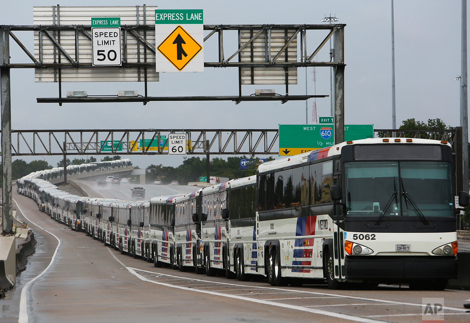 As a preventative measure, empty Metro buses are lined up in the center lanes of Interstate 59 near Cavalcade in case their bus shelters flood, Saturday, Aug. 26, 2017, in Houston. (Mark Mulligan/Houston Chronicle via AP)