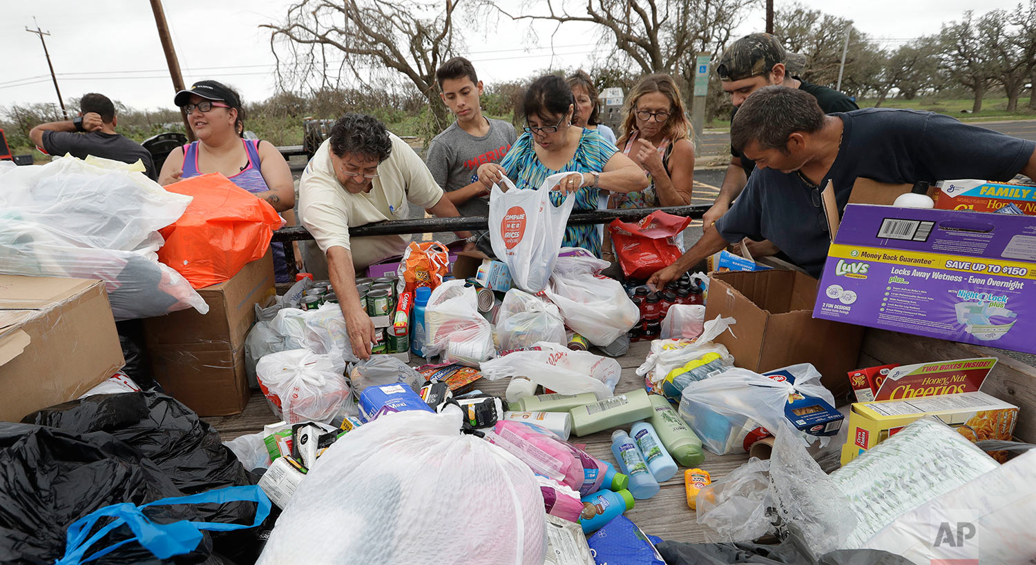 Residents pick through needed items at a make-shift aid station, Sunday, Aug. 27, 2017, in Rockport, Texas. A group from the Texas Rio Grande Valley created the station for those in need following Hurricane Harvey. (AP Photo/Eric Gay)