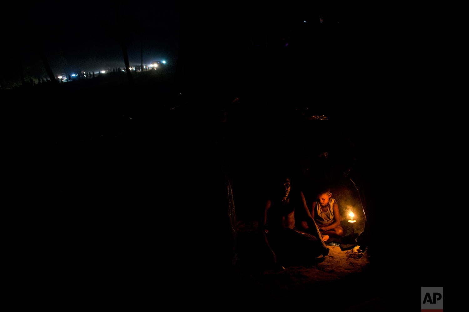 Rohingya Muslims rest inside a new tent next to Kutupalong refugee camp in Ukhia, Bangladesh, Tuesday, Sept. 5, 2017. Bangladesh, one of the world's poorest countries, was already sheltering some 100,000 Rohingya refugees before another 123,000 flooded in after Aug. 25, according to the U.N. refugee agency's latest estimate on Tuesday. (AP Photo/Bernat Armangue)