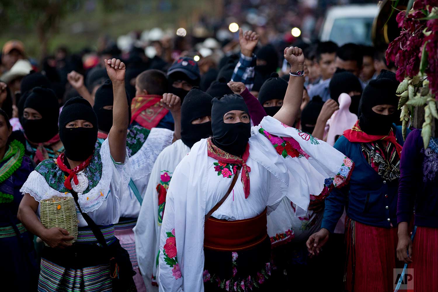  In this Sunday, Oct. 15, 2017 photo, masked indigenous women raise their fists to show support for Maria de Jesus Patricio, presidential candidate for the National Indigenous Congress, during a rally in the Zapatista stronghold of Morelia, in the southern state of Chiapas, Mexico. (AP Photo/Eduardo Verdugo) 