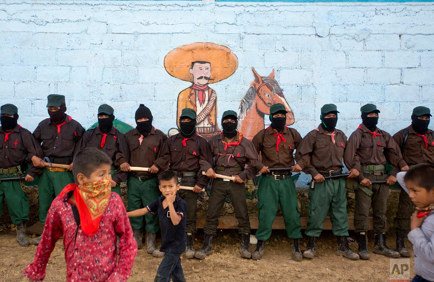  In this Monday, Oct. 16, 2017 photo, members of the Zapatista National Liberation Army (EZLN) provide security for a campaign rally by presidential candidate for the National Indigenous Congress, Maria de Jesus Patricio, in the Zapatista stronghold of La Garrucha in the southern state of Chiapas, Mexico. (AP Photo/Eduardo Verdugo) 