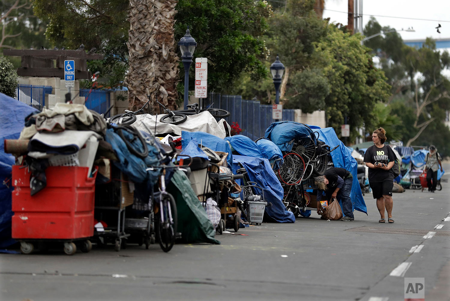  In this Sept. 19, 2017 photo, trash from homeless encampments lines a street in San Diego. In a place that bills itself as “America’s Finest City,” renowned for its sunny weather, surfing and fish tacos, spiraling real estate values have contributed to spiraling homelessness in San Diego. Most alarmingly, the explosive growth in the number of people living outdoors has contributed to a hepatitis A epidemic.  (AP Photo/Gregory Bull) 