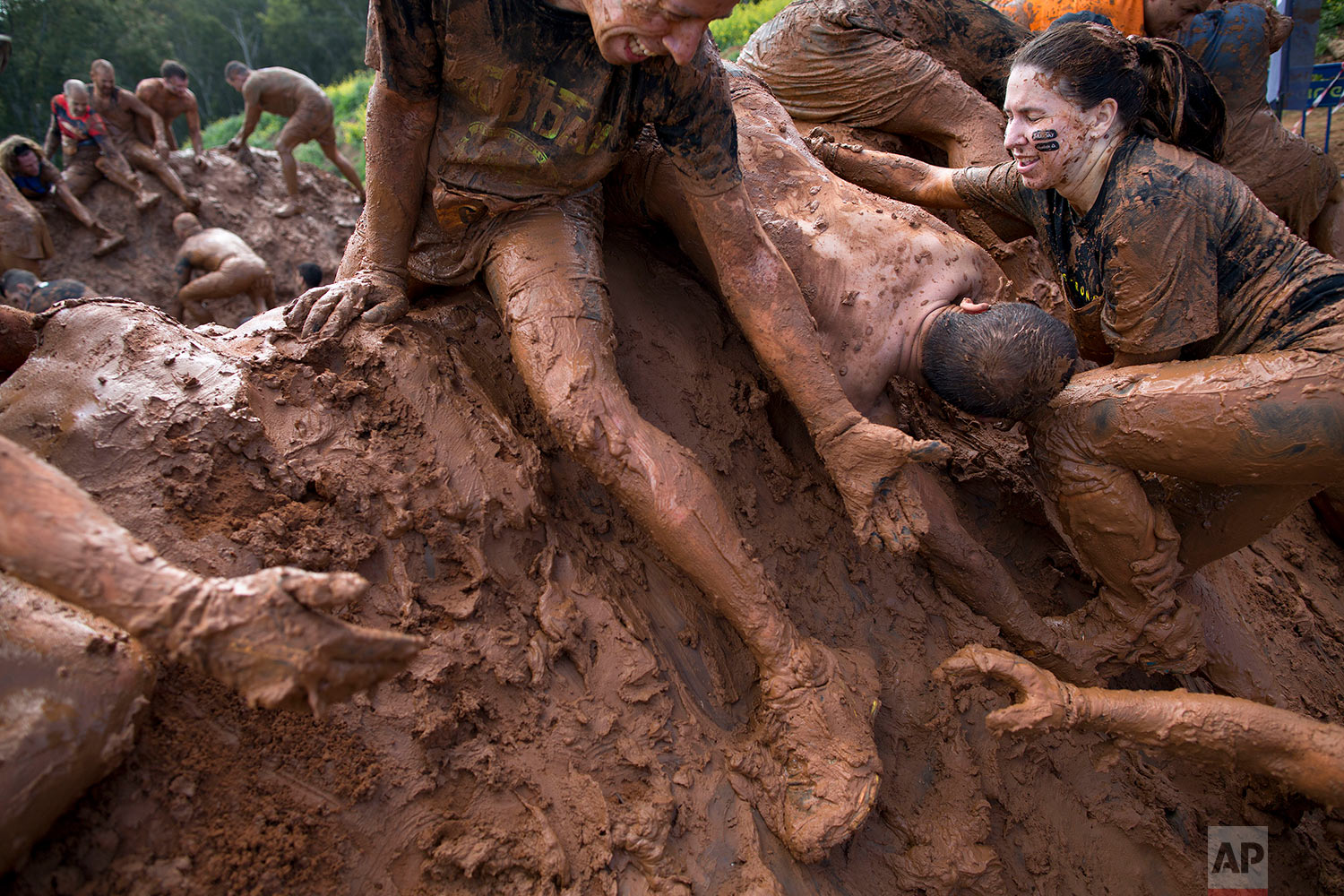  People take part in the Mud Day race, a 13 kilometer obstacle course in Tel Aviv, Israel, Friday, March 24, 2017. (AP Photo/Oded Balilty) 