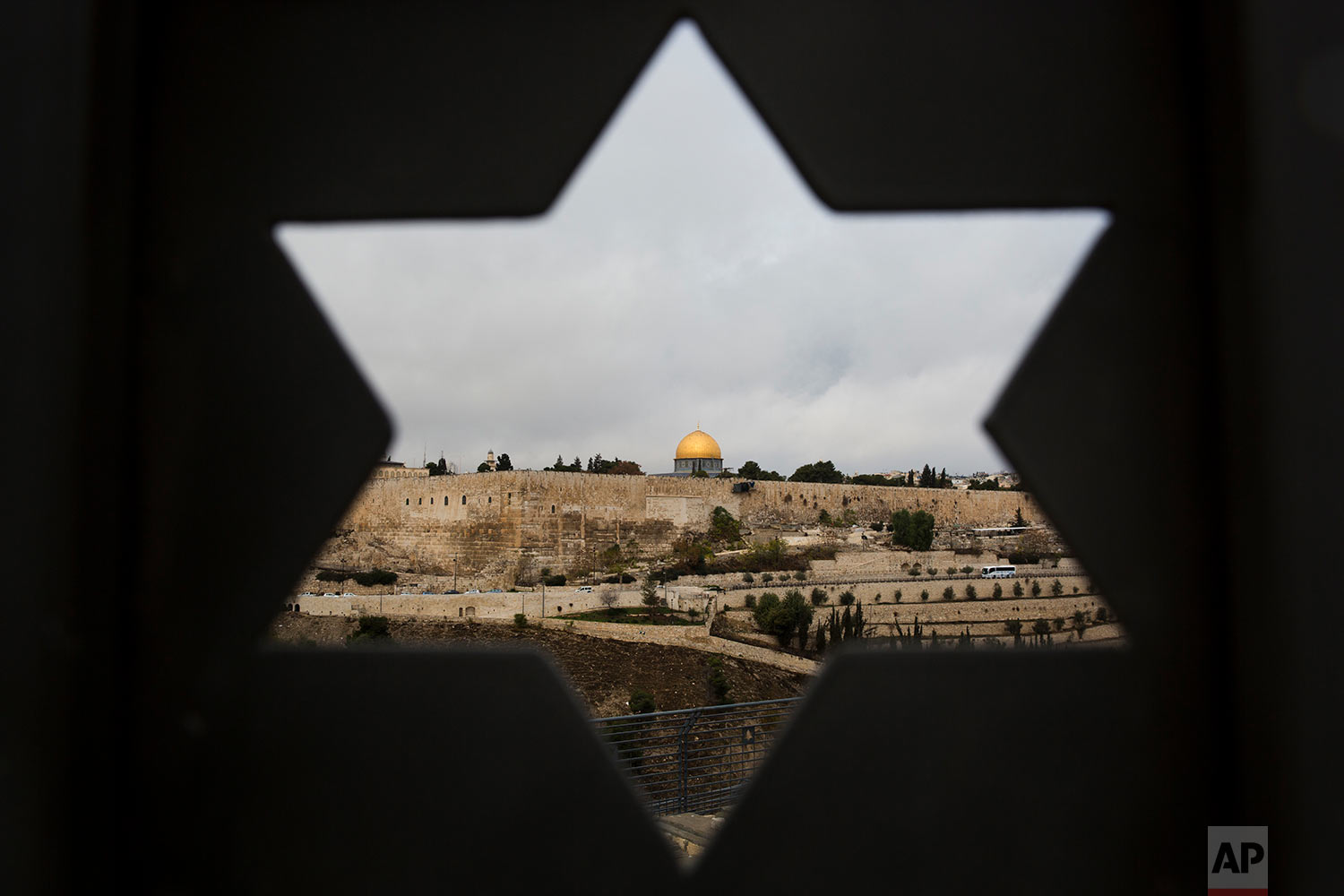  Jerusalem Old City is seen trough a door with the shape of star of David, in Jerusalem, Wednesday, Dec. 6, 2017. U.S. officials say President Donald Trump will recognize Jerusalem as Israel's capital Wednesday, Dec. 6, and instruct the State Department to begin the multi-year process of moving the American embassy from Tel Aviv to the holy city. His decision could have deep repercussions across the region. (AP Photo/Oded Balilty) 
