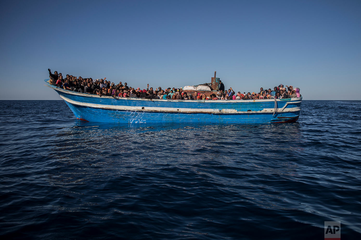  In this Tuesday, Jan. 16, 2018, photo, about 450 Sub-Saharan refugees and migrants, mostly from Eritrea, wait to be rescued by aid workers of Spanish NGO Proactiva Open Arms, as they were trying to leave the Libyan coast and reach European soil aboard an overcrowded wooden boat, 34 miles north of Kasr-El-Karabulli, Libya. (AP Photo/Santi Palacios)&nbsp; |&nbsp; See these photos on AP Images  