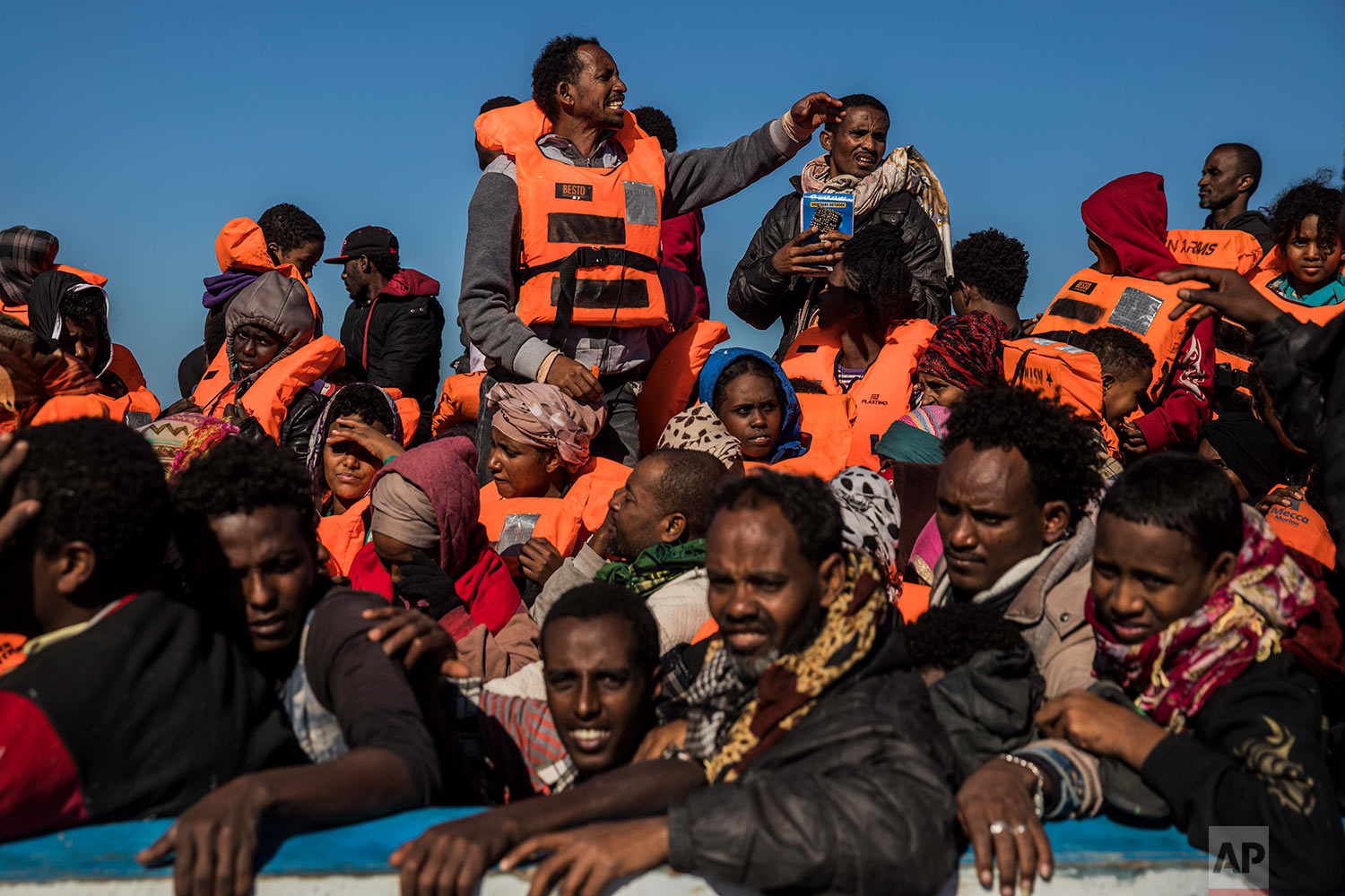  In this Tuesday, Jan. 16, 2018 photo, about 450 Sub-Saharan refugees and migrants, mostly from Eritrea, wait to be rescued by aid workers of Spanish NGO Proactiva Open Arms, as they were trying to leave the Libyan coast and reach European soil aboard an overcrowded wooden boat, 34 miles north of Kasr-El-Karabulli, Libya. (AP Photo/Santi Palacios) |&nbsp; See these photos on AP Images  