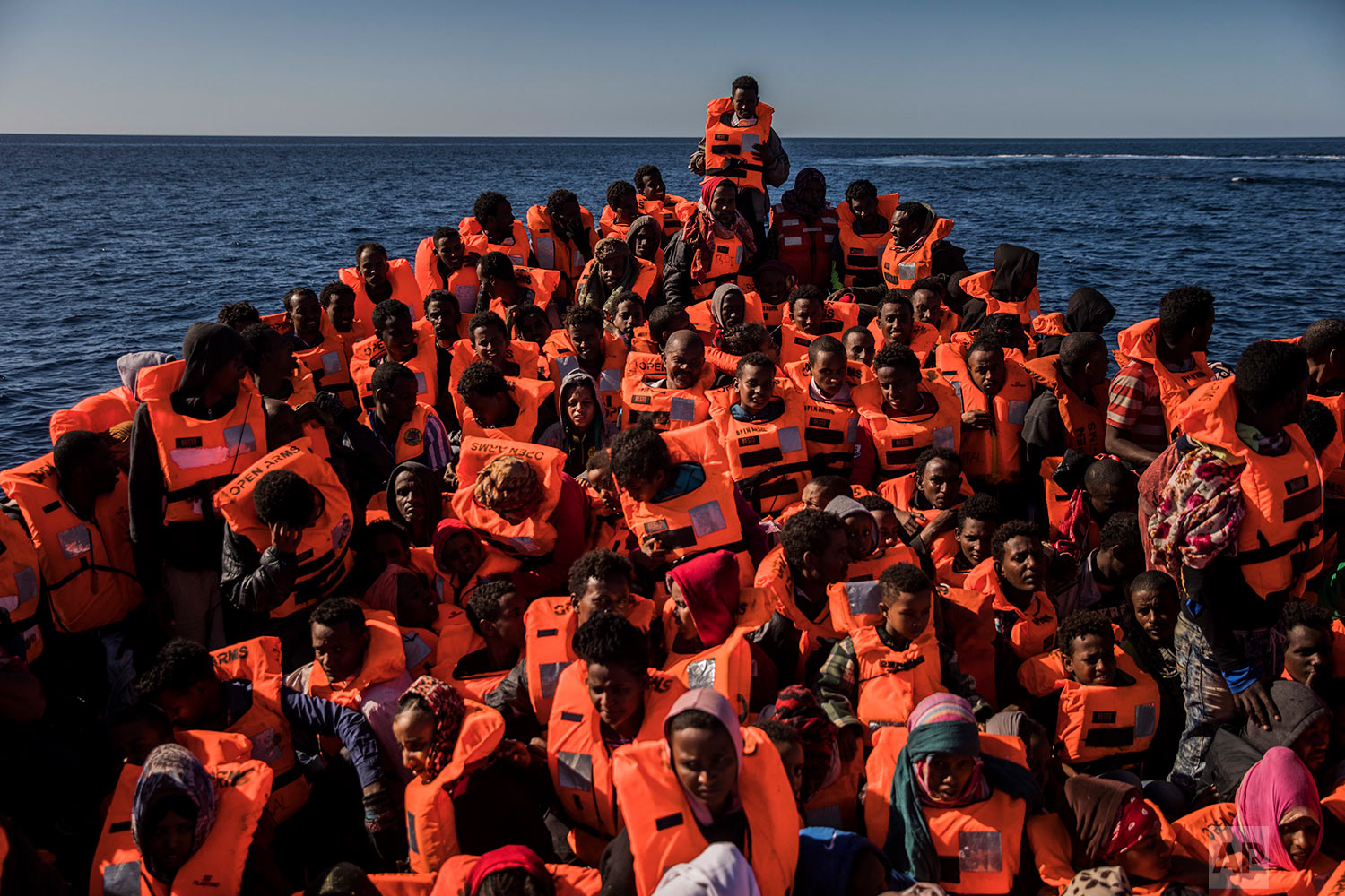  In this Tuesday, Jan. 16, 2018 photo, about 450 Sub-Saharan refugees and migrants, mostly from Eritrea, wait to be rescued by aid workers of Spanish NGO Proactiva Open Arms, as they were trying to leave the Libyan coast and reach European soil aboard an overcrowded wooden boat, 34 miles north of Kasr-El-Karabulli, Libya. (AP Photo/Santi Palacios)&nbsp; |&nbsp; See these photos on AP Images  