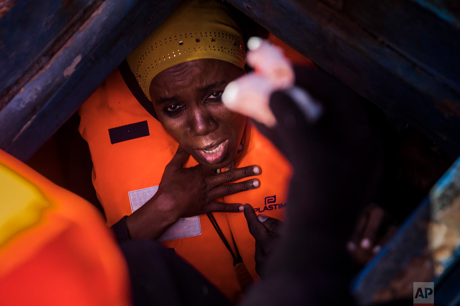  In this Tuesday, Jan. 16, 2018 photo a woman from Eritrea tries to breathe inside the lower deck of a wooden boat with 450 people aboard, as they were trying to leave the Libyan coast and reach European soil, 34 miles north of Kasr-El-Karabulli, Libya. (AP Photo/Santi Palacios)&nbsp; |&nbsp; See these photos on AP Images  