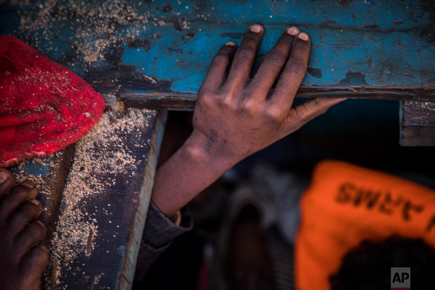  In this Tuesday, Jan. 16, 2018 photo, a boy from Eritrea tries to leave the lower deck of a wooden boat with 450 people on board, as they were trying to leave the Libyan coast and reach European soil, 34 miles north of Kasr-El-Karabulli, Libya. (AP Photo/Santi Palacios)&nbsp; |&nbsp; See these photos on AP Images  