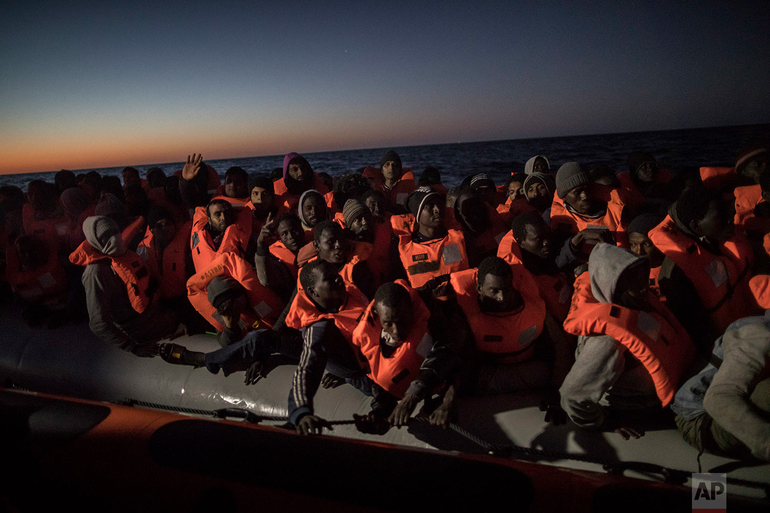  In this Tuesday, Jan. 16, 2018, photo, Sub-Saharan refugees and migrants from different nationalities trying to leave the Libyan coast and reach European soil aboard an overcrowded rubber boat are rescued by a team of aid workers from the Spanish NGO Proactiva Open Arms, 28 miles north of Al Khums, Libya. (AP Photo/Santi Palacios)&nbsp; |&nbsp; See these photos on AP Images  