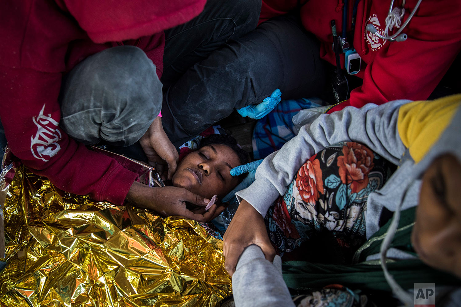  In this Thursday, Jan. 18, 2018 photo a doctor from the Spanish NGO Proactiva Open Arms assists an Eritrean woman as the organization's rescue vessel heads to Italy with more than 300 refugees and migrants on board. (AP Photo/Santi Palacios)&nbsp; |&nbsp; See these photos on AP Images  