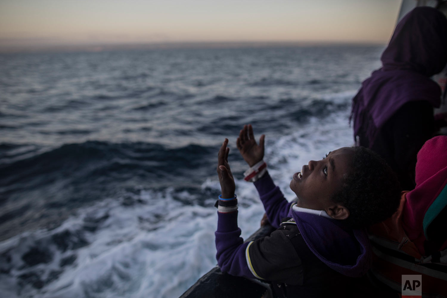  In this Friday, Jan. 19, 2018 photo a child from Eritrea sings to celebrate his arrival to Europe aboard the Spanish NGO Proactiva Open Arms rescue vessel, Pozzallo, Sicily, Italy. (AP Photo/Santi Palacios)&nbsp; |&nbsp; See these photos on AP Images  