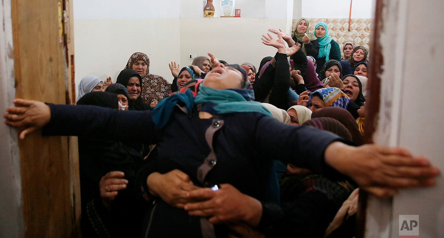  Relatives mourn during the funeral for Hamdan Abu Amsha, 23, at the family's house in Beit Hanoun, Gaza Strip, Saturday, March 31, 2018. Israel will target "terror organizations" in Gaza if violence along the territory's border with Israel drags on, the chief military spokesman warned Saturday, a day after thousands of Palestinians staged protests near the border fence. (AP Photo/Adel Hana) 
