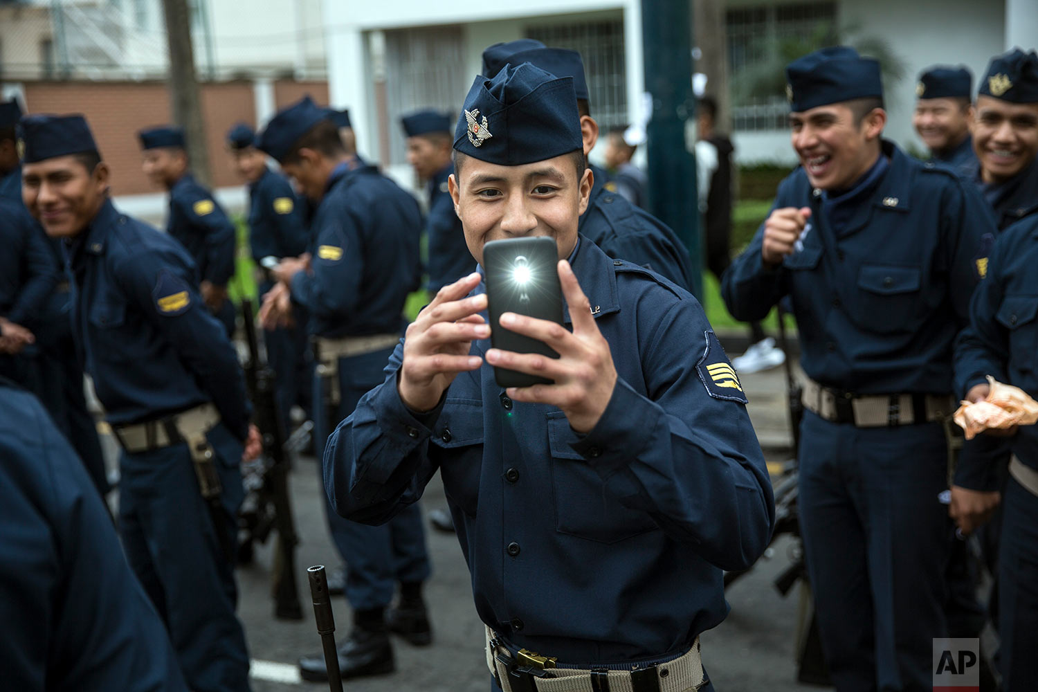  A soldier takes a cell phone picture of journalists before the start of a military parade, part of Independence Day celebrations in Lima, Peru, July 29, 2018. (AP Photo/Rodrigo Abd) 