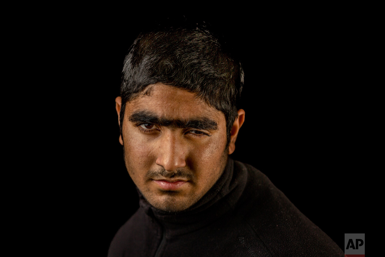 In this Nov. 29, 2016 photo, Faisal Ahmad poses for a portrait in the village of Karimabad, Indian-controlled Kashmir. Metal pellets shot by Indian security forces wounded Faisal during a raid in his village, losing eyesight on his left eye. The most recent protests erupted in early July after Indian troops killed Burhan Wani, a young and charismatic militant commander and sparked off more than five months of angry street protests in the Kashmir valley. (AP Photo/Bernat Armangue)