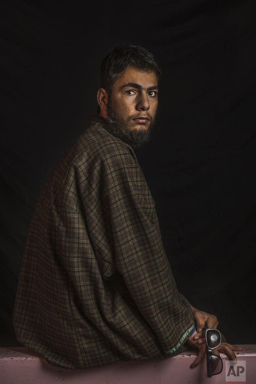In this Dec. 1, 2016 photo, Nasir Fayaz Mir, 16, poses for a portrait in Pattan, Indian-controlled Kashmir. The most recent protests erupted in early July after Indian troops killed Burhan Wani, a young and charismatic militant commander and sparked off more than five months of angry street protests in the Kashmir valley. Health officials say that in the past five months more than 6,000 people, mostly young men, have been injured by shotgun pellets, including hundreds blinded in one or both eyes. Nasir was wounded in July and lost eyesight in his right eye. He has to wear sunglasses to protect his damaged eyes from the light and the dust. "I felt as the whole universe turned dark." (AP Photo/Bernat Armangue)