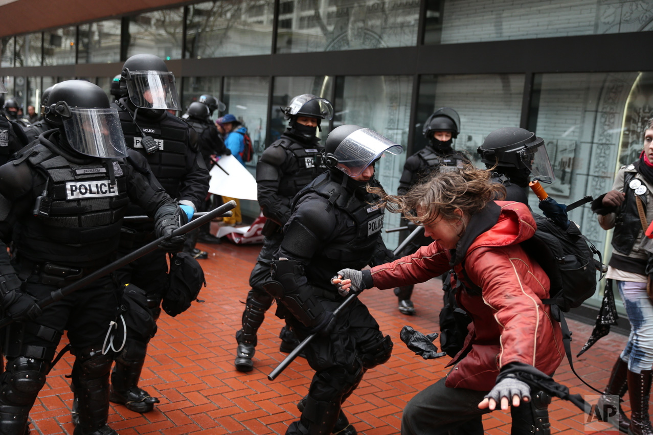 Protesters clash with police in Portland, Ore., on Monday, Feb. 20, 2017. Thousands of demonstrators turned out Monday across the U.S. to challenge President Donald Trump in a Presidents Day protest dubbed "Not My President's Day." (Dave Killen/The Oregonian via AP)