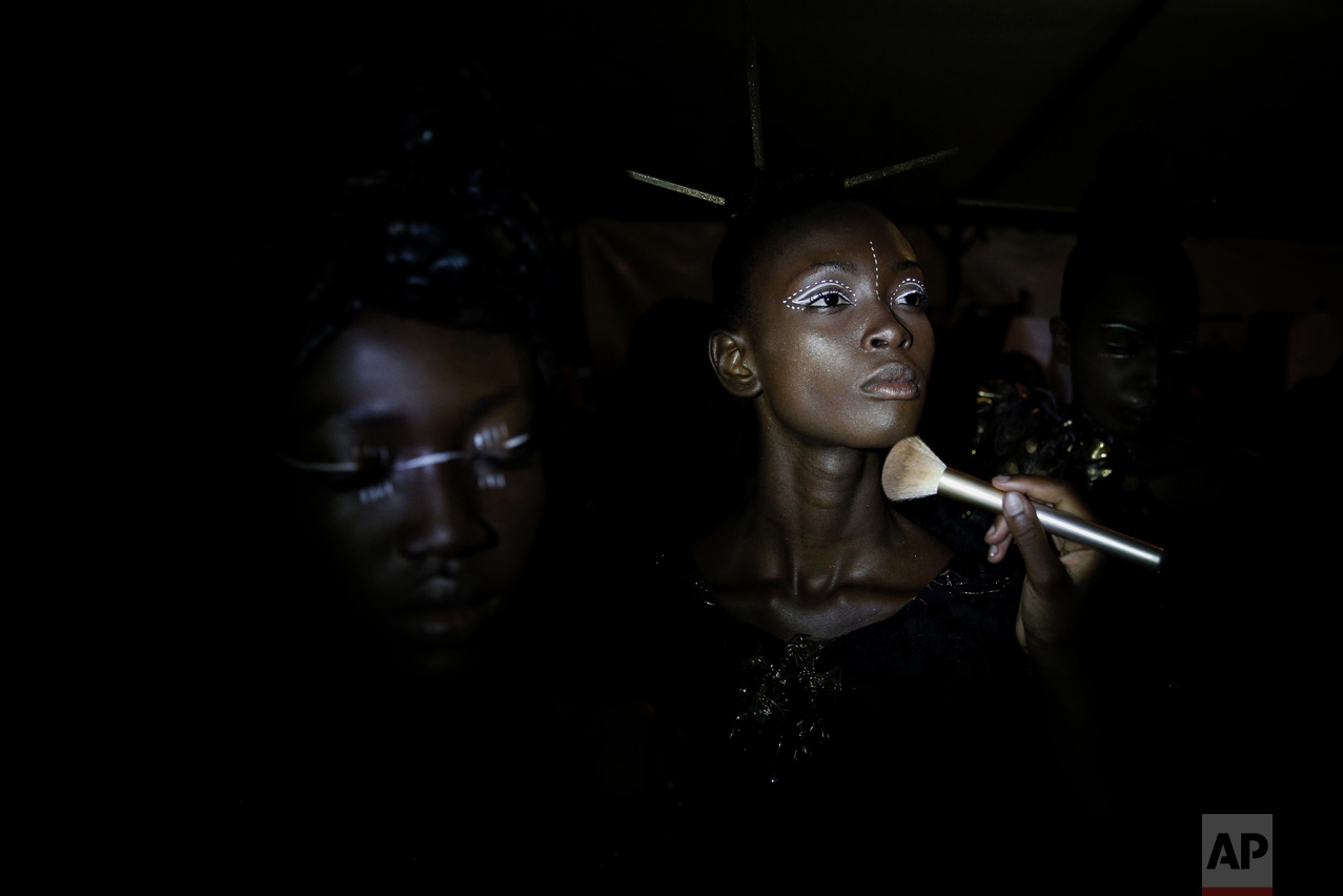 A model has her make up done backstage during Dakar Fashion Week in the Senegalese capital, Friday June 30, 2017. (AP Photo/Finbarr O'Reilly)