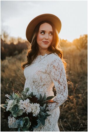 fall-bride-looking-behind-shoulder-while-wearing-sun-hat-sun-setting-bridals-look-for-the-light-photo-video