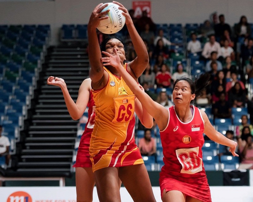 Melody Teo of Singapore tries in vain to stop Sri Lankan player Tharjini Sivalingam