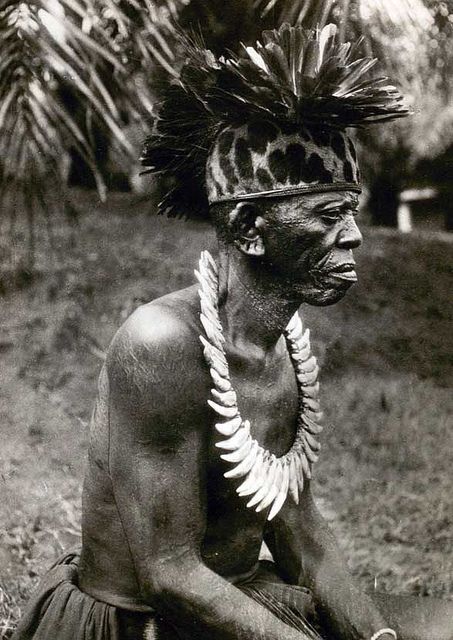 Chief from the Lokele tribe, western Congo. Feather headdresses and leopard-tooth necklaces were typically seen on chiefs in the African "interior". (1937)