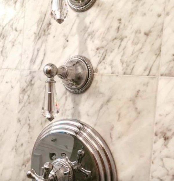 Crystal knobs against marble with a chrome finish 