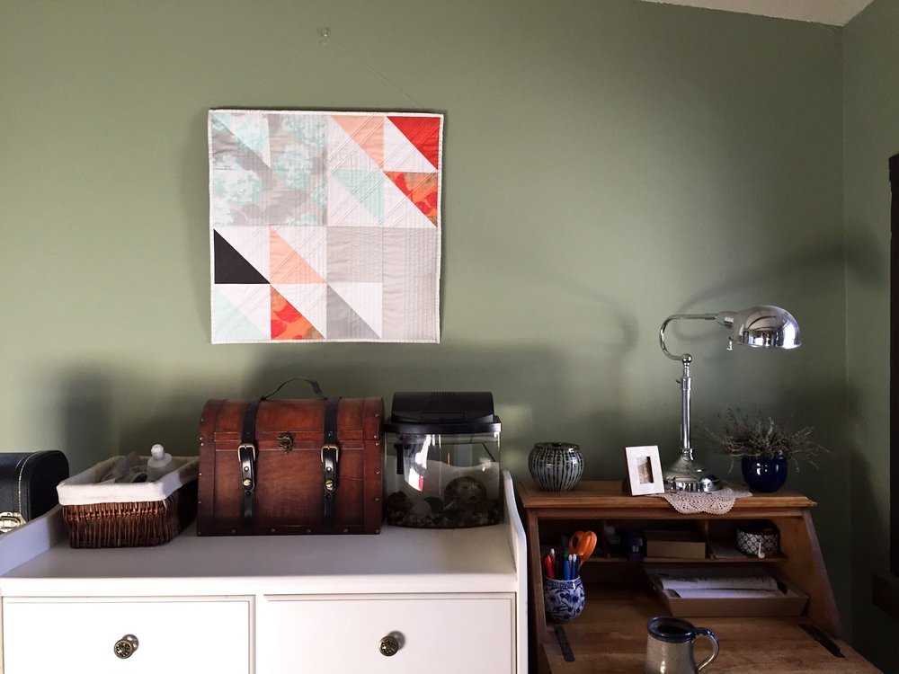 Fresh Starts mint and coral modern wall quilt living in its Wheaton home | by Lovely and Enough