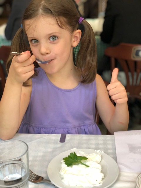 Olivia’s first greek yogurt - an obvious thumbs up.
