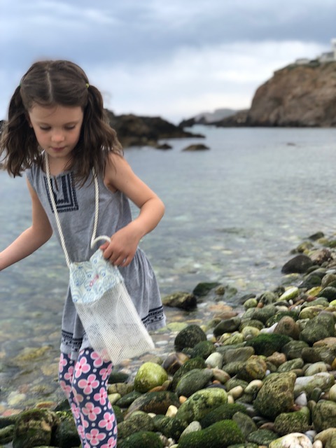 searching for sea glass on the rocky shore near the Portara