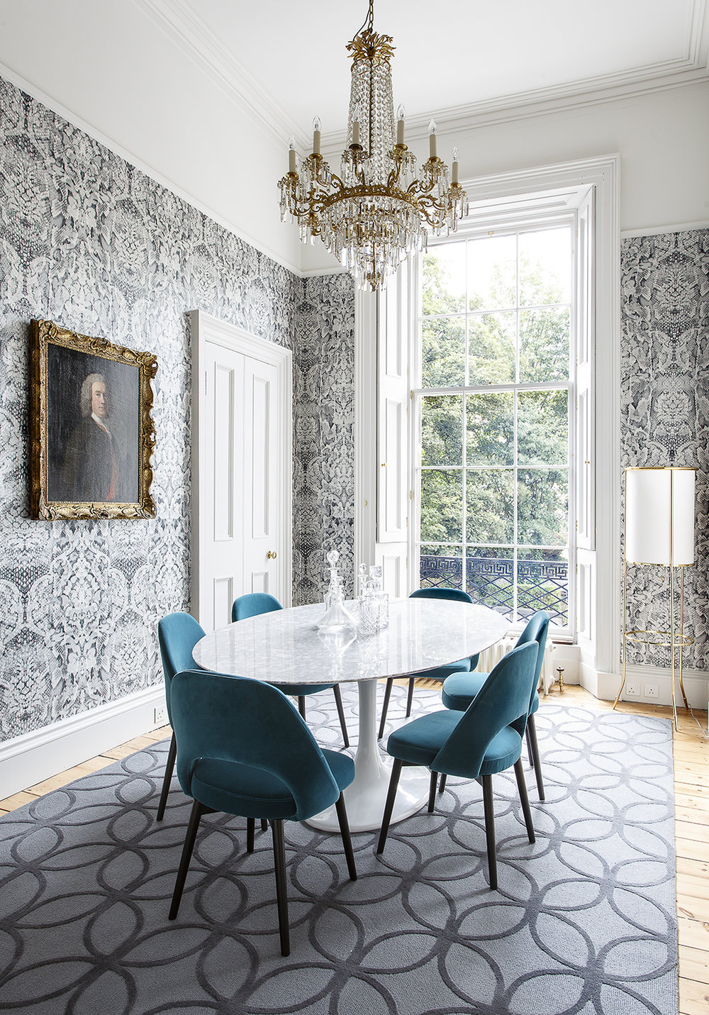 dining room mixes a Georgian chandelier with mid-century Knoll furniture and edgy Damask wallpaper by the Glasgow-based design duo Timorous Beasties.