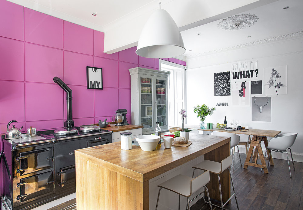    The shocking pink MDF paneling is painted in ‘Flamingo’ by Dulux. The pendant light above the island unit was an investment buy from Best Lite.   