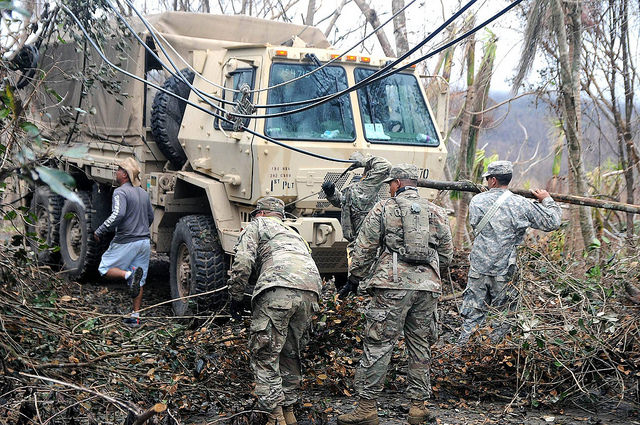 National Guard officials, alongside residents of the municipality of Cayey, conduct a route clearing mission after the destruction left by Hurricane Maria. Photo: The National Guard