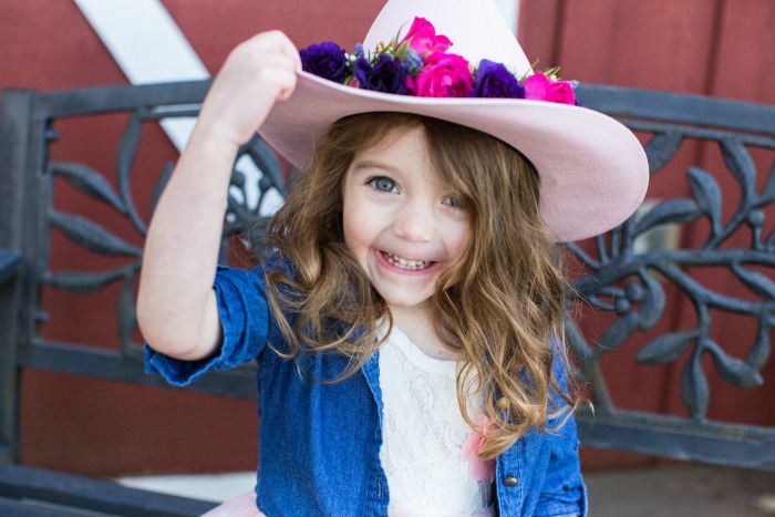 My Addy, proudly showing off her floral crown-adorned cowgirl hat.