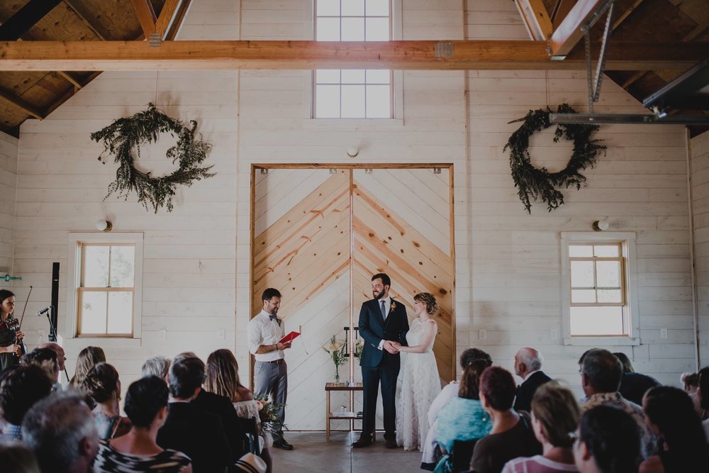 My second wedding in July was Jenna and Joe, they were married at the Croft Farm on Sauvie Island in Portland and although it was SUPER hot that day, it was such an incredible day. They decided to move their outdoor ceremony into the barn which ended up being absolutely adorable and kept everyone out of the heat. I adored how they chose to stand together on one side with their officiant on the other, I thought that was so sweet and unique! Photo by  Kyle Carnes Photography