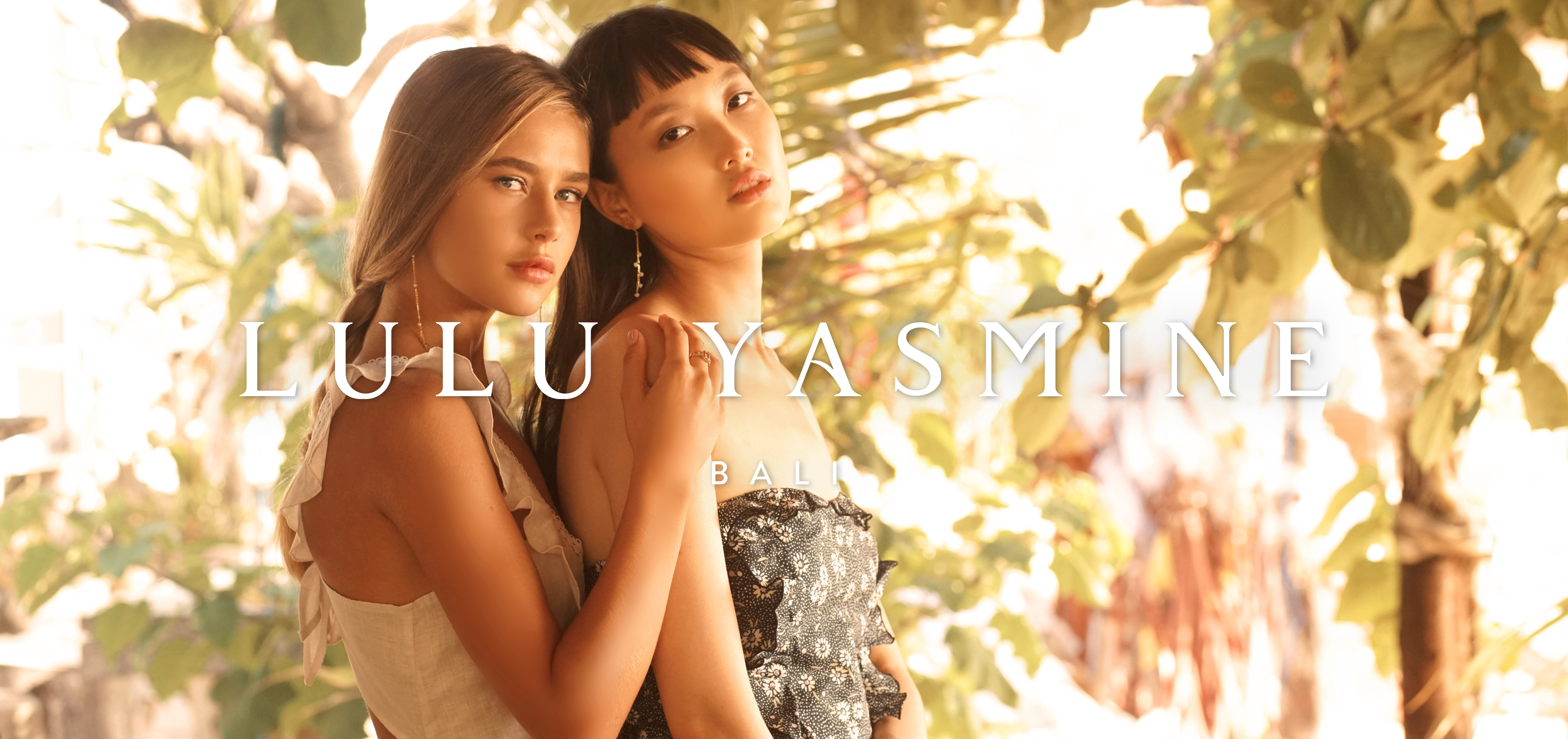 A picture of two woman in fashionable clothes looking at the camera. The Lulu Yasmine Logo is overlaid on top, and the International Visual Identity Awards logo in the bottom left corner.
