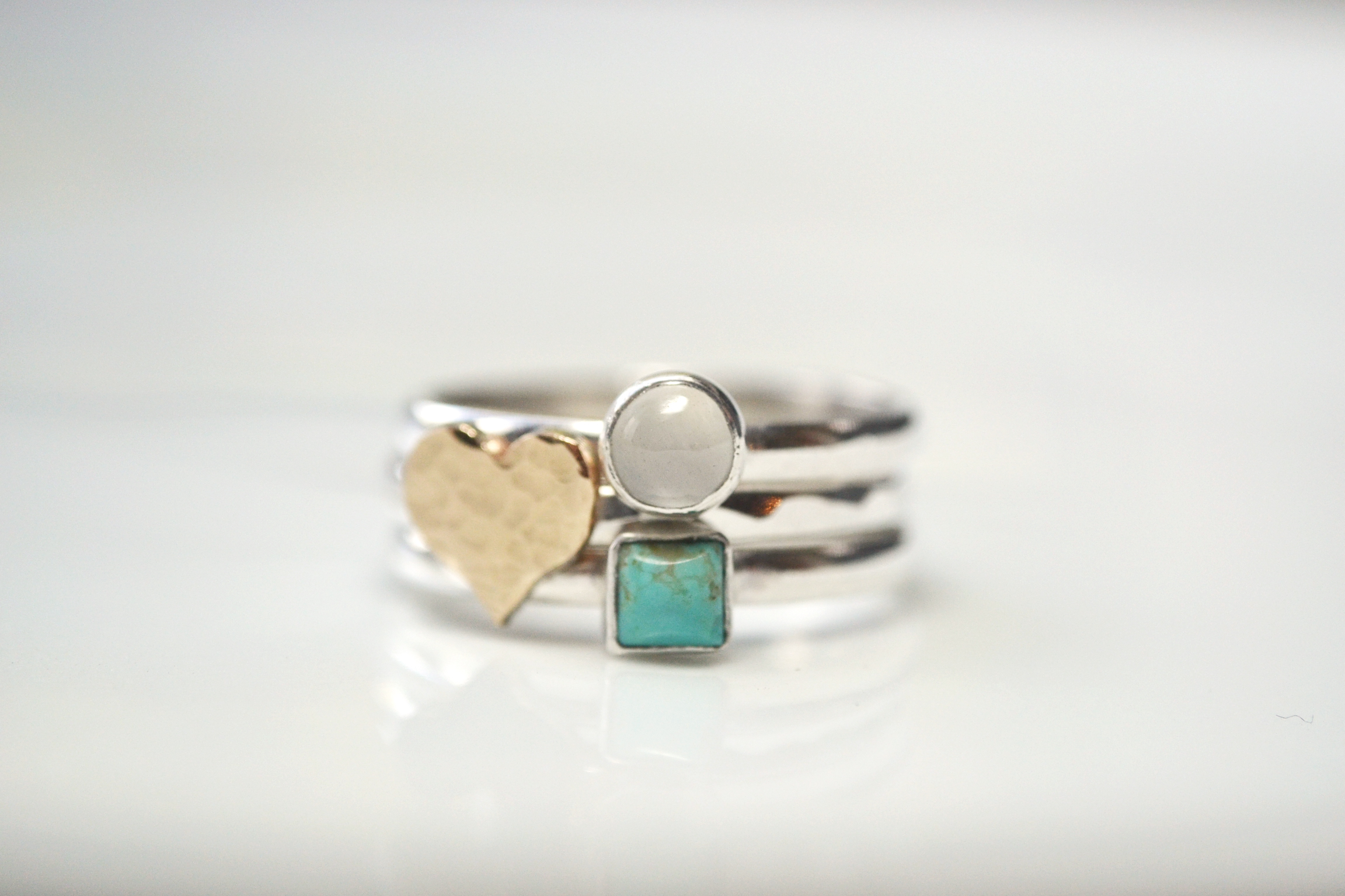Gold heart with a 5mm moonstone and a 4mm turquoise square.