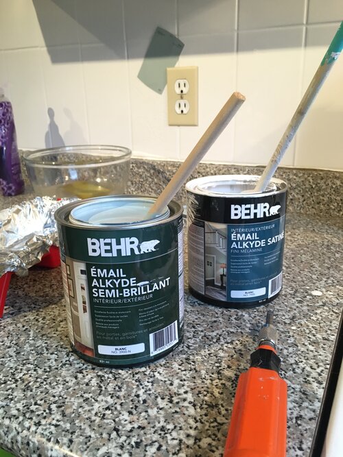 The can on the right is the Behr Alkyd Semi Gloss in Watery - the can on the left is the left over Behr Alkyd Satin Melamine Finish in White that was left over from the tile project.