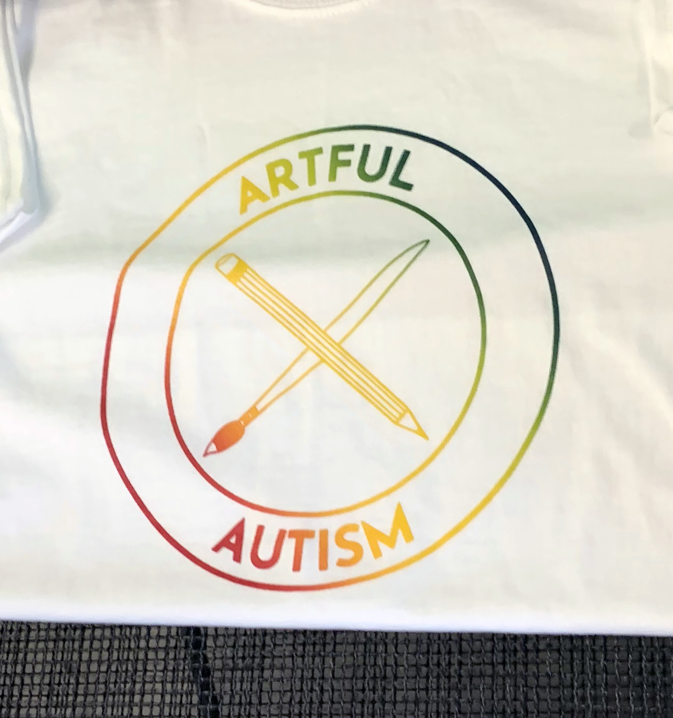 Screen printed logo: Artful Autism done in a rainbow gradient