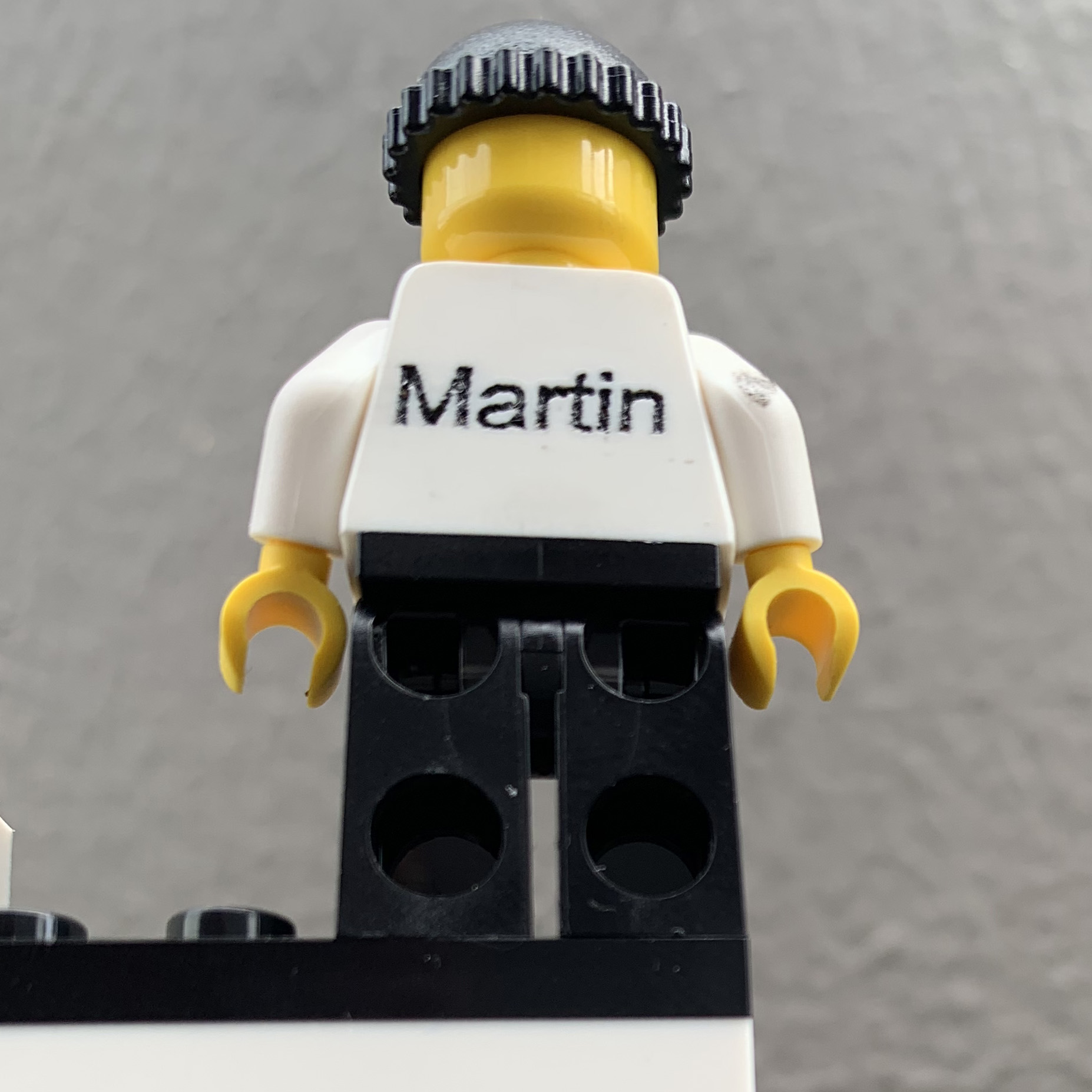 Laser Engraving: the name 'Martin' engraved on the back of a lego figure.
