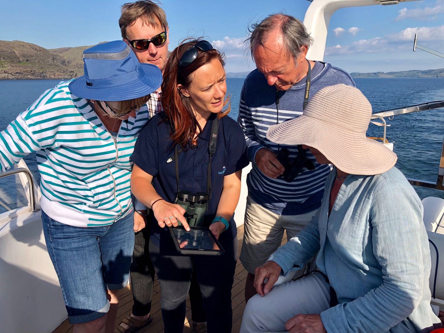 Wildlife Guide Lynsey using the Whale Track app with Hebrides Cruises guests