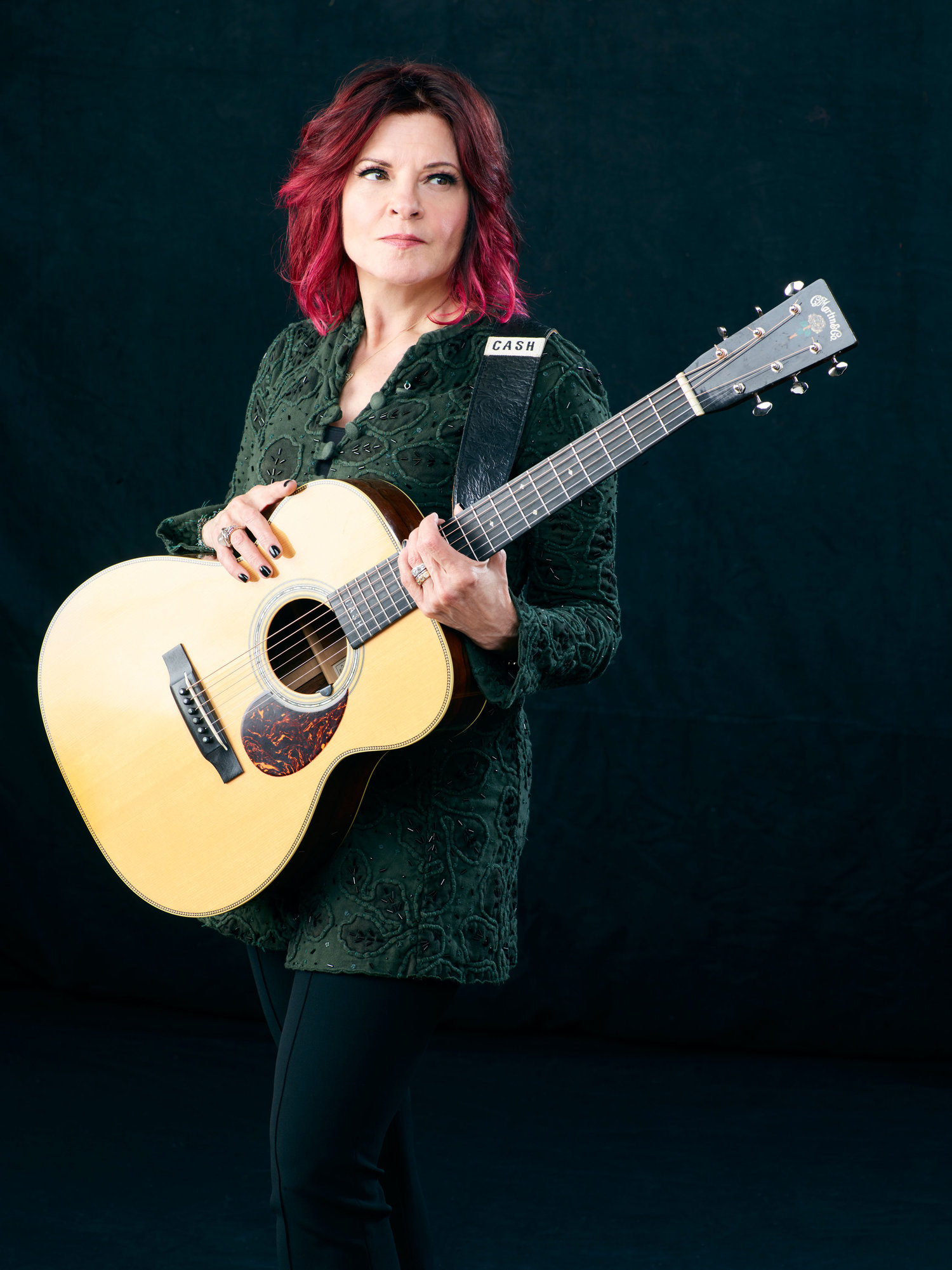Photo of Roseanne Cash holding a guitar