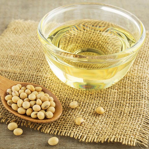soybean oil and soybeans on a wooden table