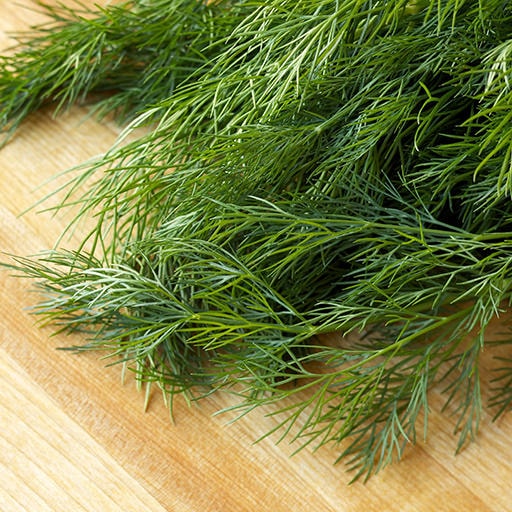 dill herbs and plants on a chopping board