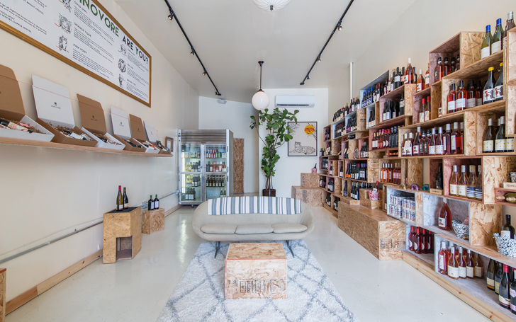 Interior of Vinovore Silverlake with wine chart on the left and shelves of wine on the right