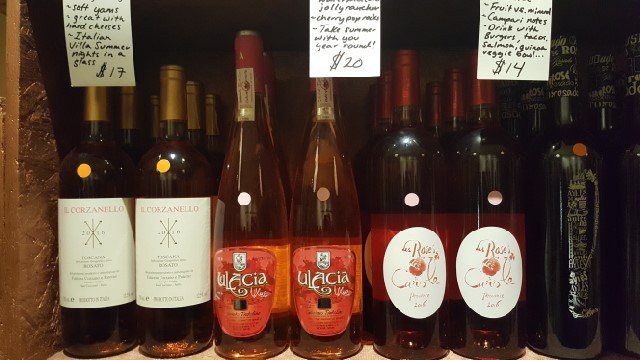 Closeup of wine bottles with handwritten tasting note cards