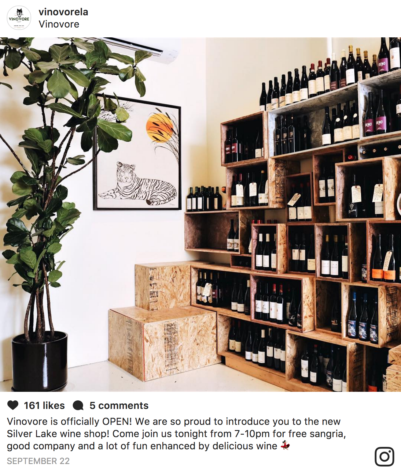 Tiger painting on the wall with wine bottles on shelves