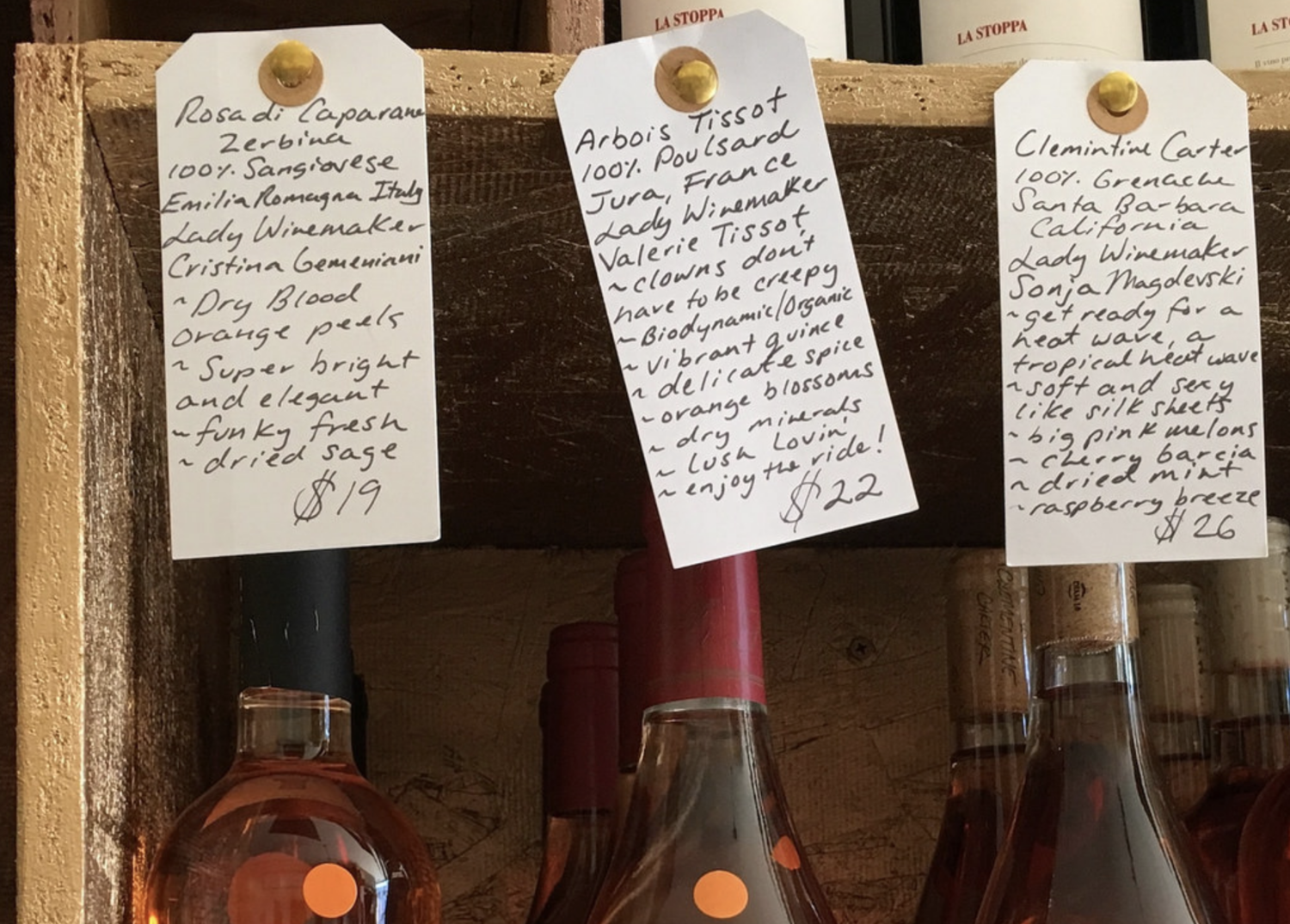 Closeup of wine bottles and hand written tasting notes