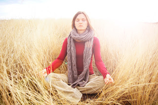 Woman in meadow meditating